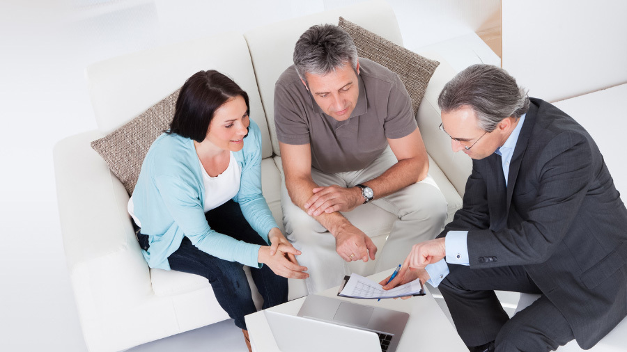 Seaside specialist speaking with clients about timeshare exit services for Gold Key Resorts.